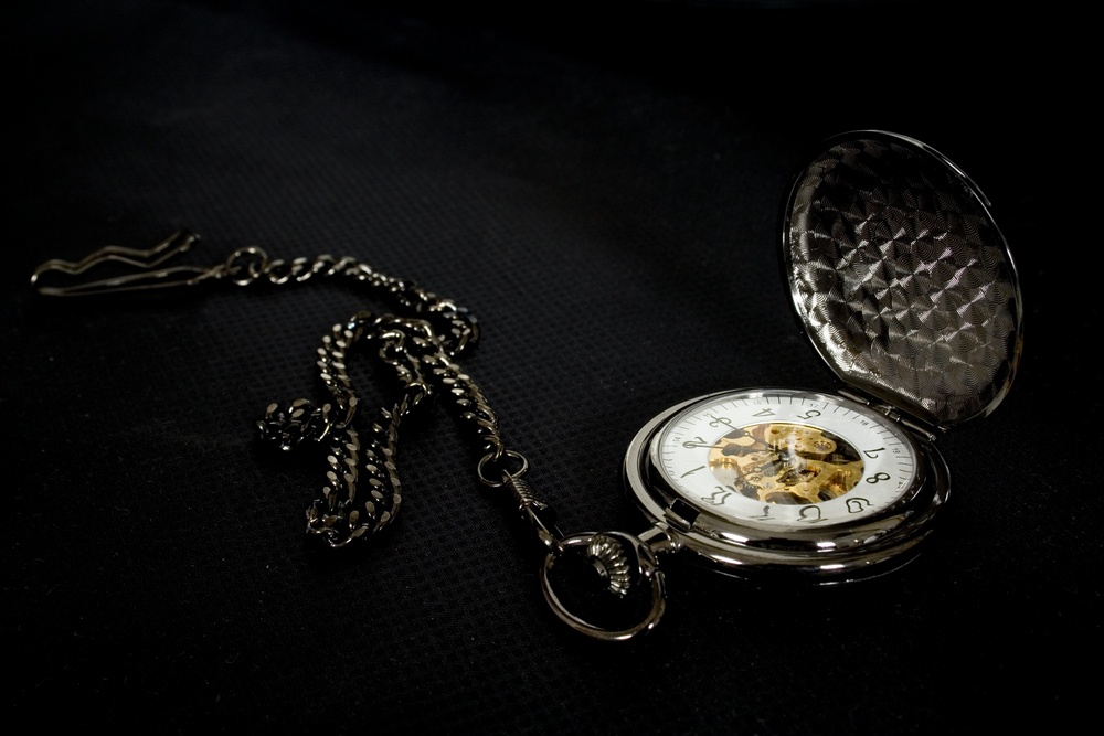 aged clock on black background